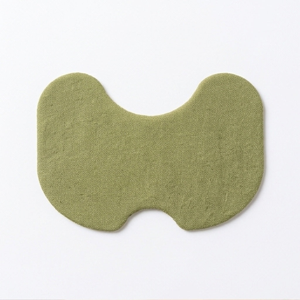 Un parche para rodilla verde de frente, con su forma de riñón y la textura de tela.